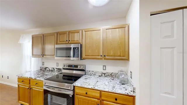 a kitchen with sink cabinets and stainless steel appliances