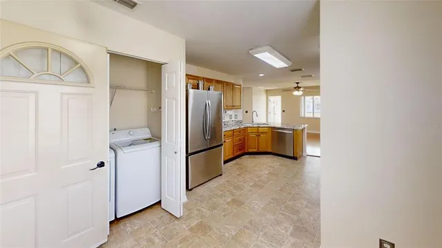 a view of a hallway to closet and utility room