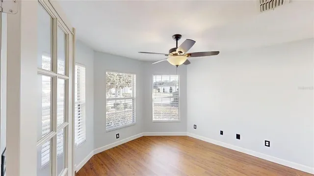 a view of room with window and ceiling fan