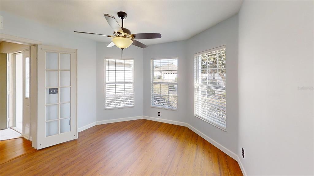 9761 Southwest 90th Street Ocala, FL 34481 - Photo 15 of 27 a view of an empty room with wooden floor and a window