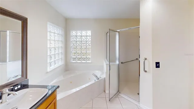 a bathroom with a tub sink and shower