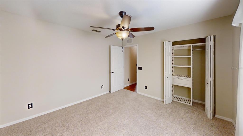 9761 Southwest 90th Street Ocala, FL 34481 - Photo 22 of 27 a view of an empty room with chandelier fan
