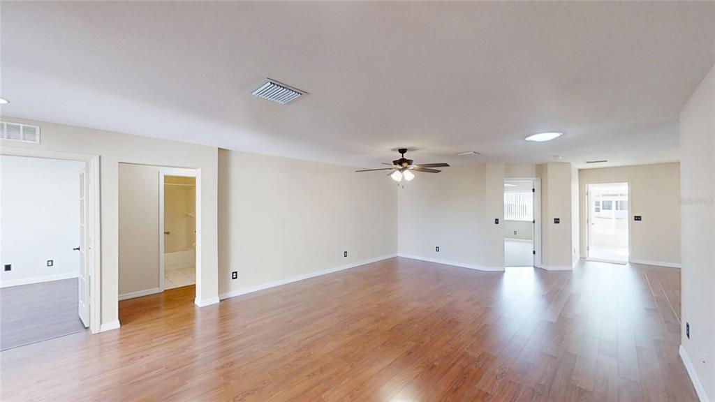 9761 Southwest 90th Street Ocala, FL 34481 - Photo 4 of 27 a view of an empty room with wooden floor
