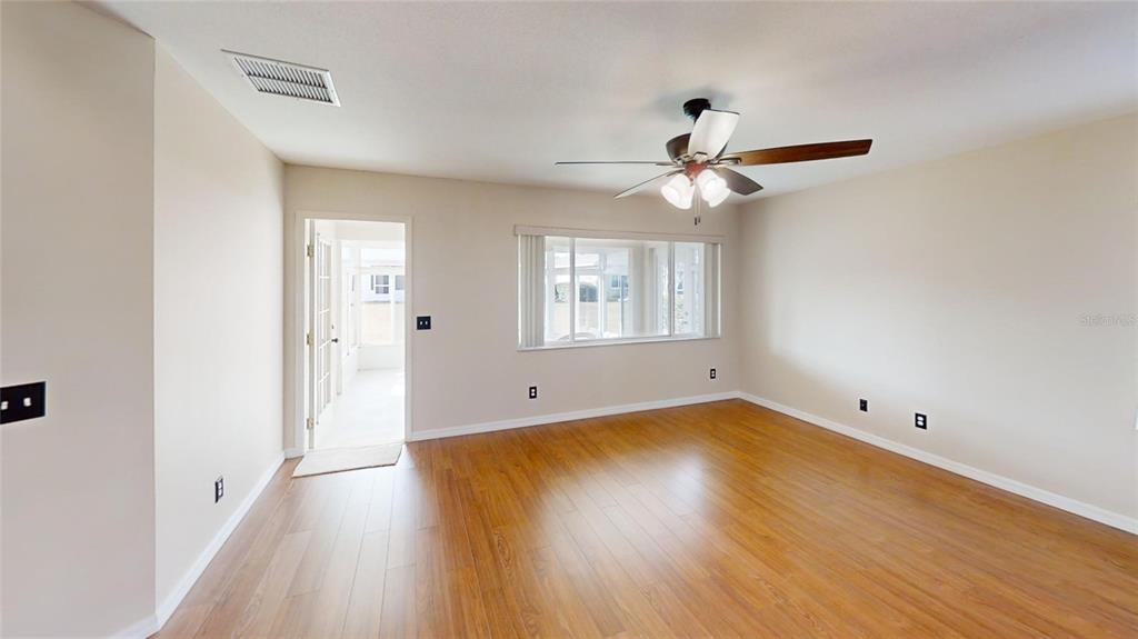 9761 Southwest 90th Street Ocala, FL 34481 - Photo 6 of 27 wooden floor in an empty room with a window