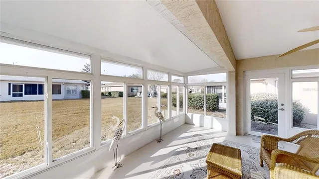 a living room with furniture floor to ceiling windows and walls