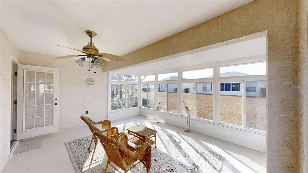 9761 Southwest 90th Street Ocala, FL 34481 - Photo 8 of 27 a living room with furniture and a large window