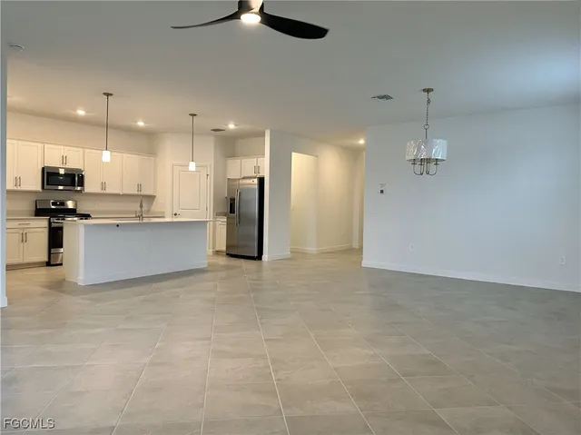 a view of kitchen with refrigerator and window