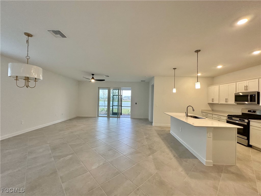 15084 Anchorage Road Punta Gorda, FL 33982 - Photo 9 of 30 a view of a kitchen with microwave and stove