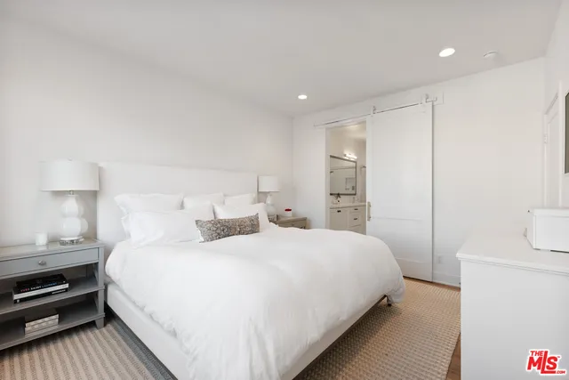 a bedroom with a bed and a night stand