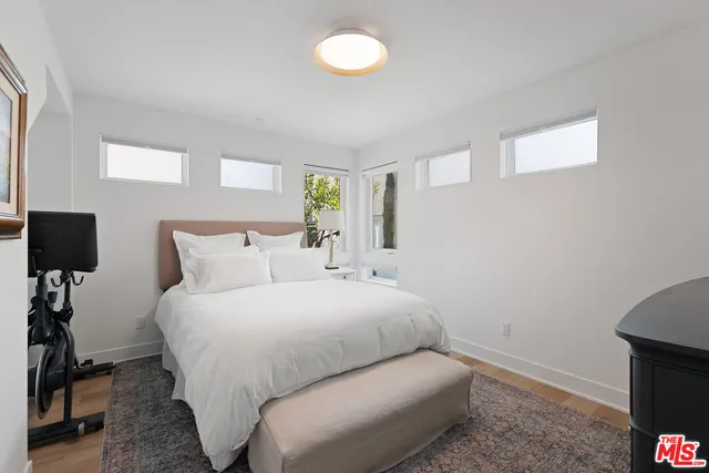 a bedroom with a bed and a night stand