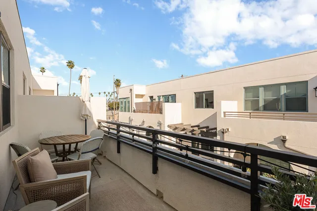 a group of chairs sitting in a balcony