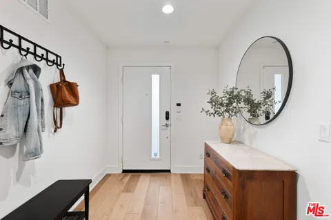 a view of a room with wooden floor and fan
