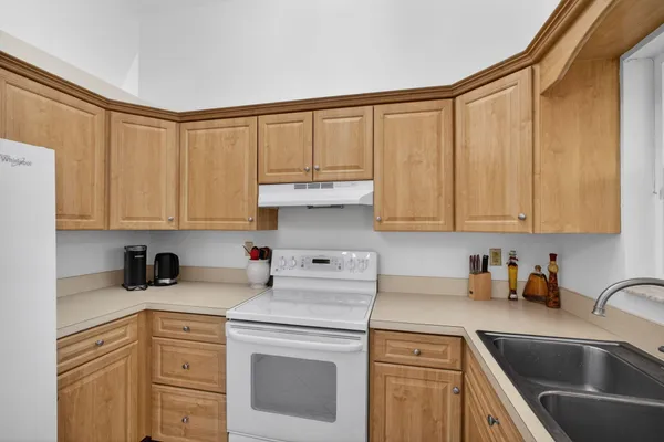a kitchen with stainless steel appliances granite countertop a sink a stove and cabinets