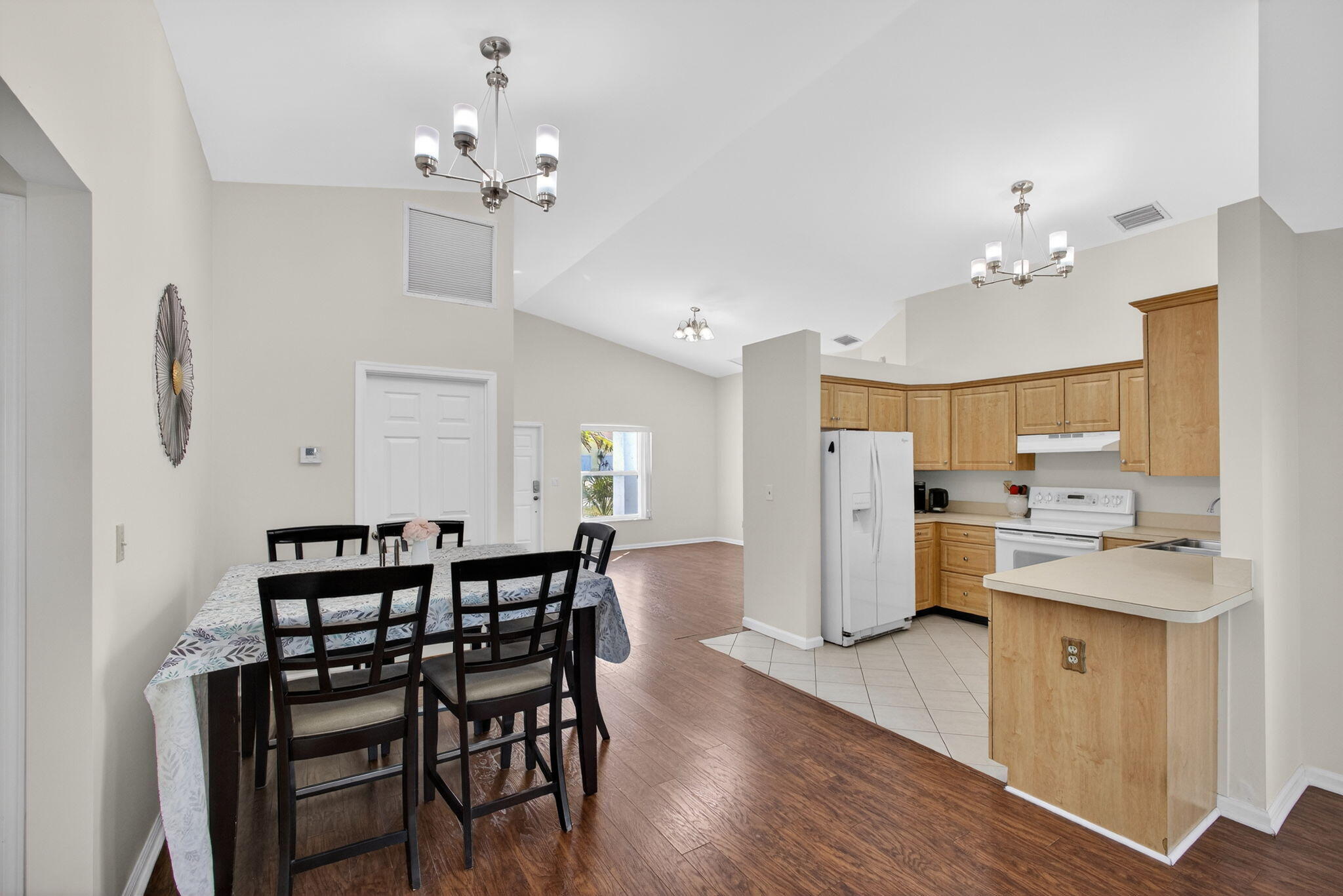 6223 Kendrick Street Jupiter, FL 33458 - Photo 20 of 45 a view of a dining room with furniture and wooden floor