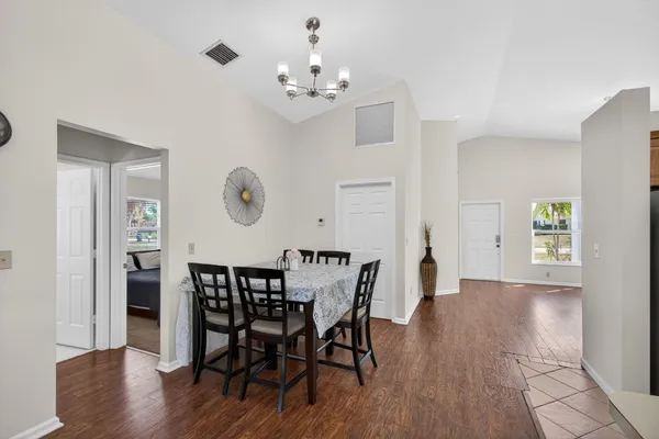 a view of a dining room with furniture and chandelier