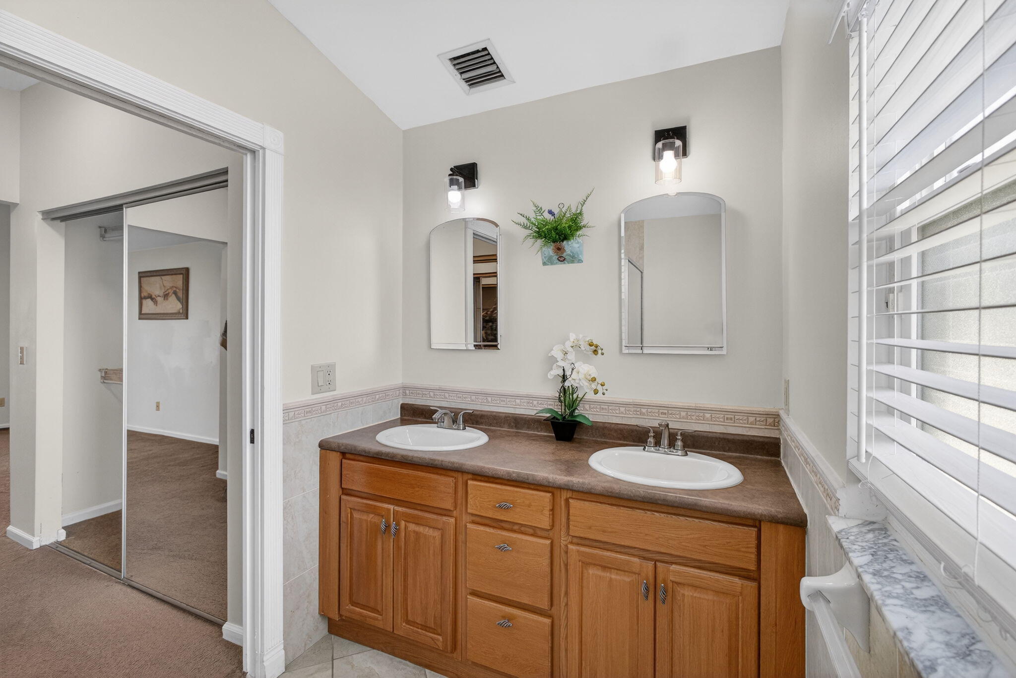 6223 Kendrick Street Jupiter, FL 33458 - Photo 25 of 45 a bathroom with a sink and a mirror