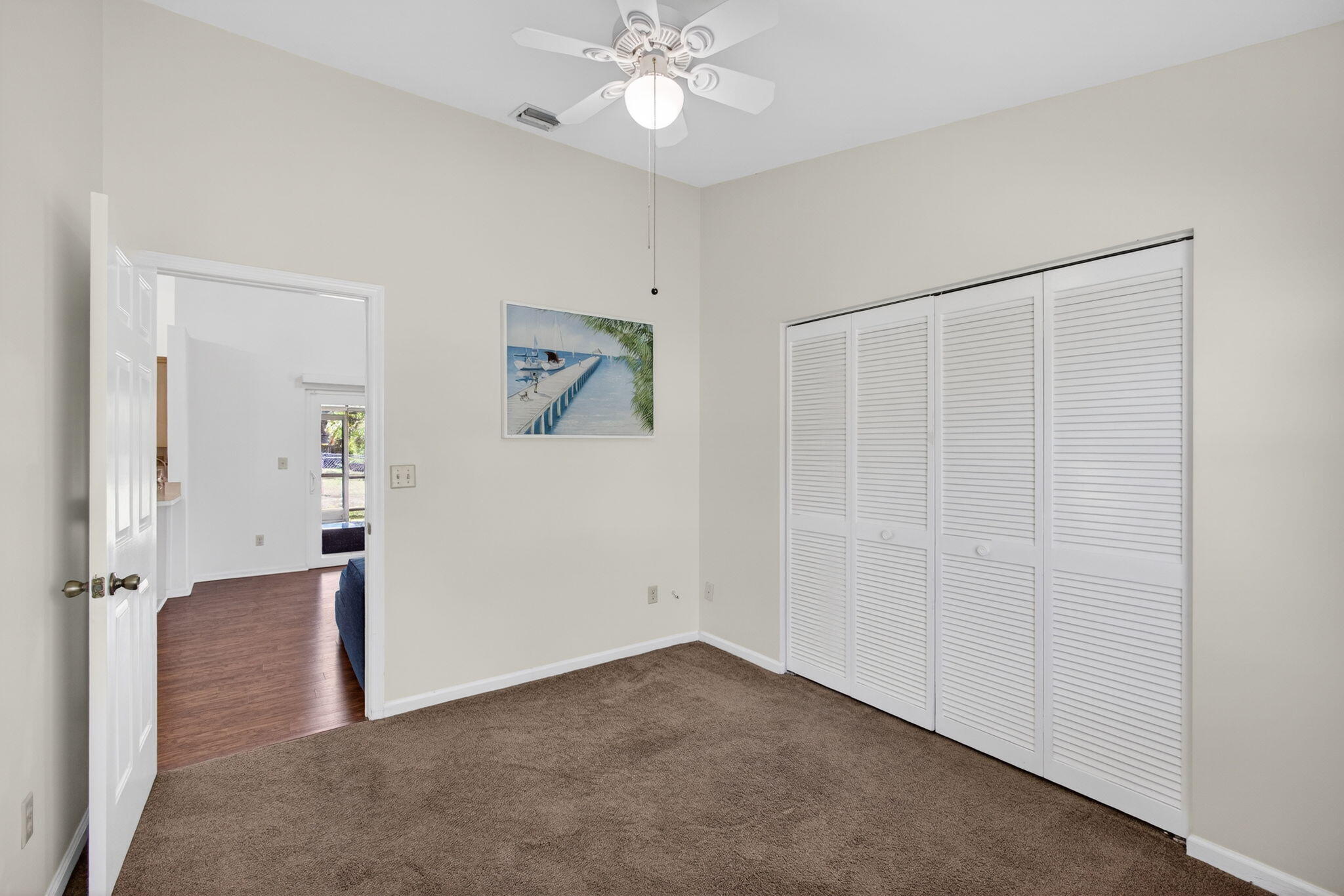 6223 Kendrick Street Jupiter, FL 33458 - Photo 29 of 45 an empty room with closet and a chandelier fan