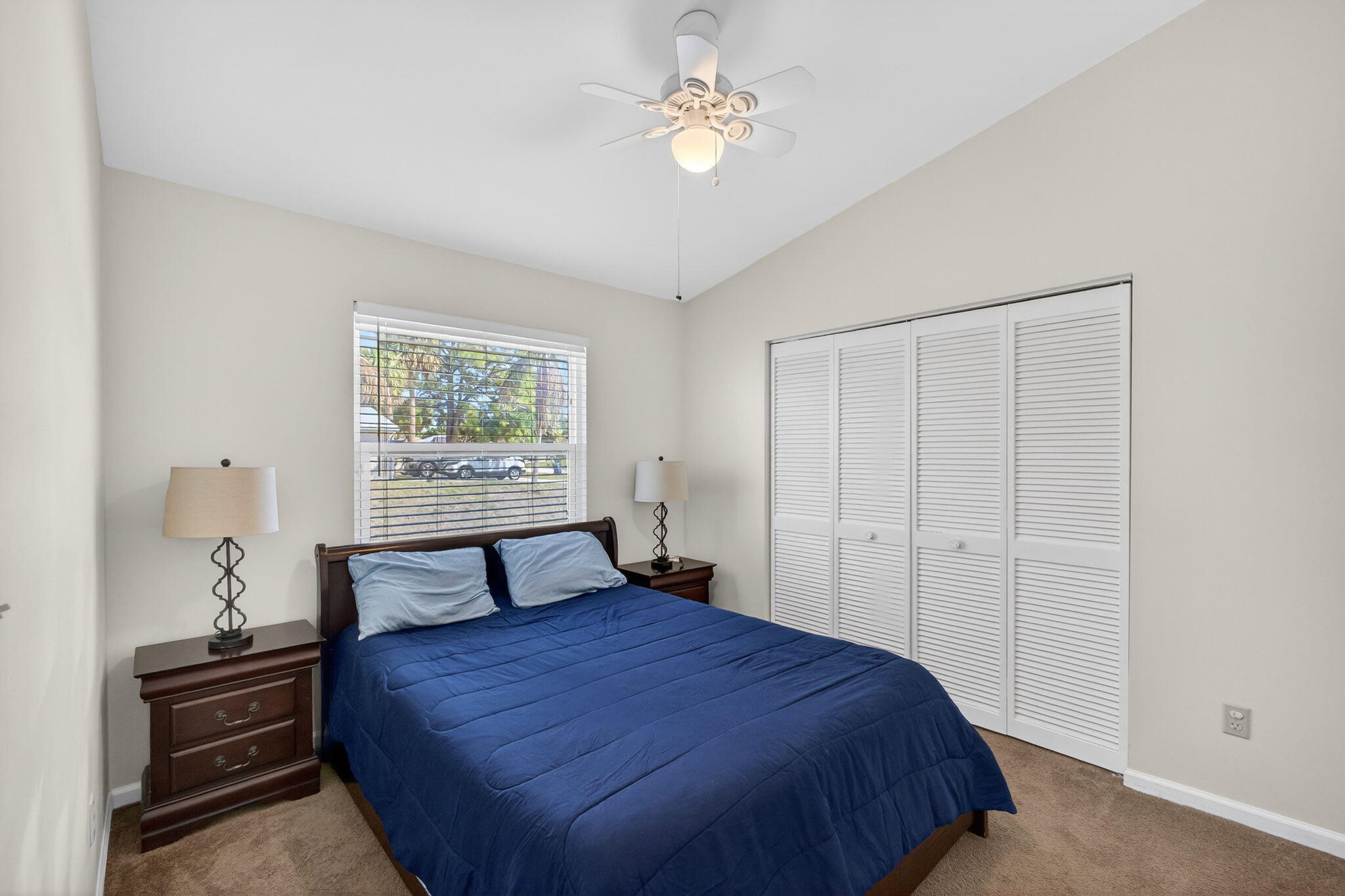 6223 Kendrick Street Jupiter, FL 33458 - Photo 34 of 45 a bedroom with a bed and a chandelier