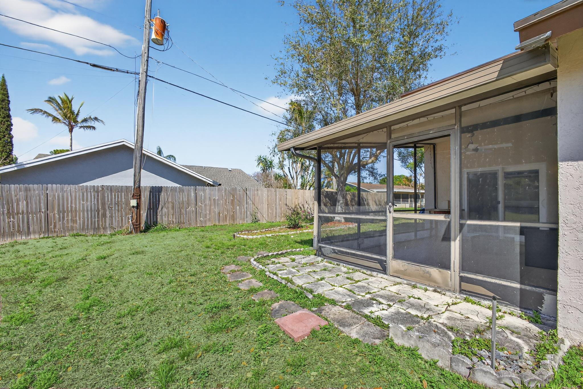 6223 Kendrick Street Jupiter, FL 33458 - Photo 38 of 45 a backyard of a house with lots of green space