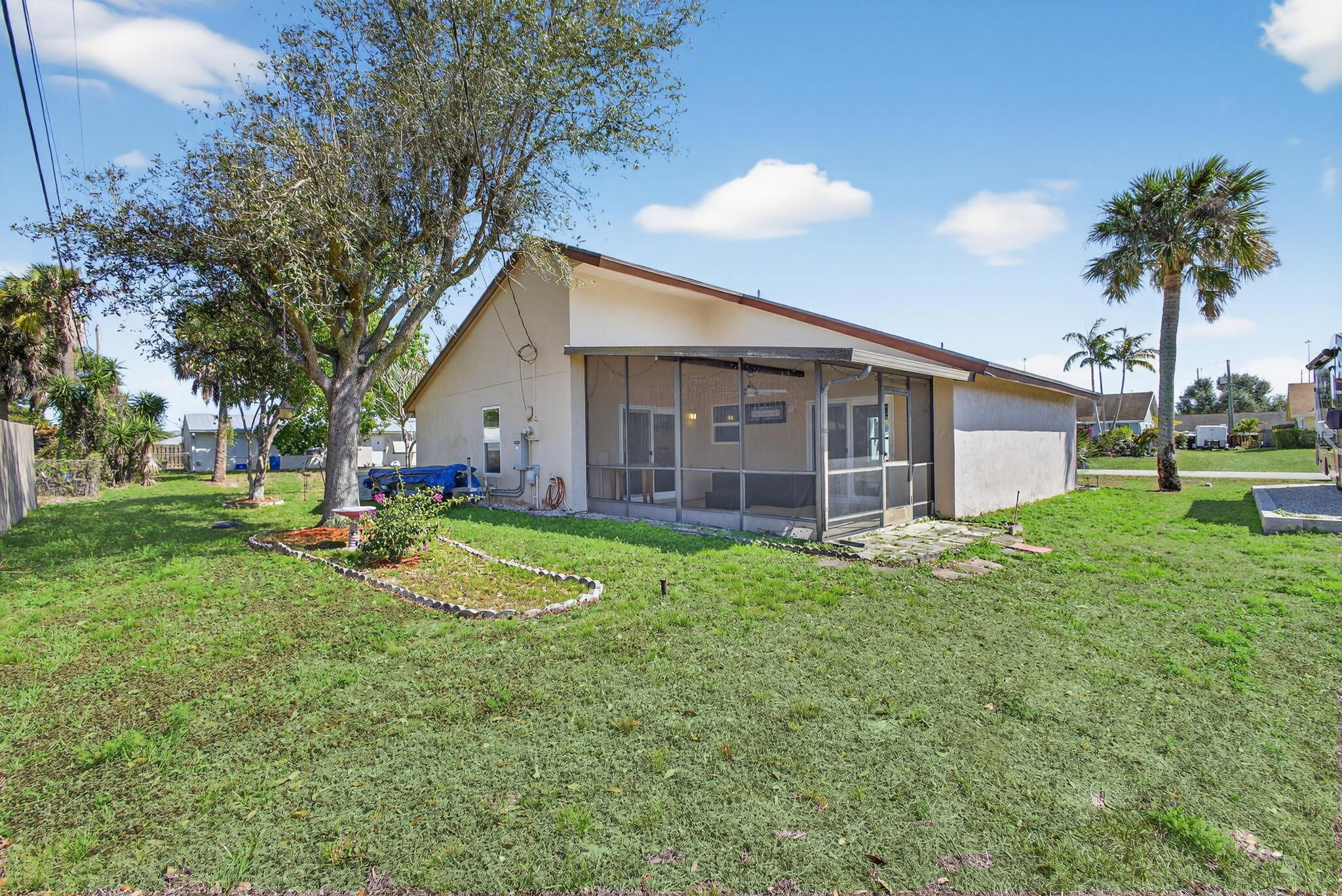 6223 Kendrick Street Jupiter, FL 33458 - Photo 39 of 45 a view of a house with a backyard