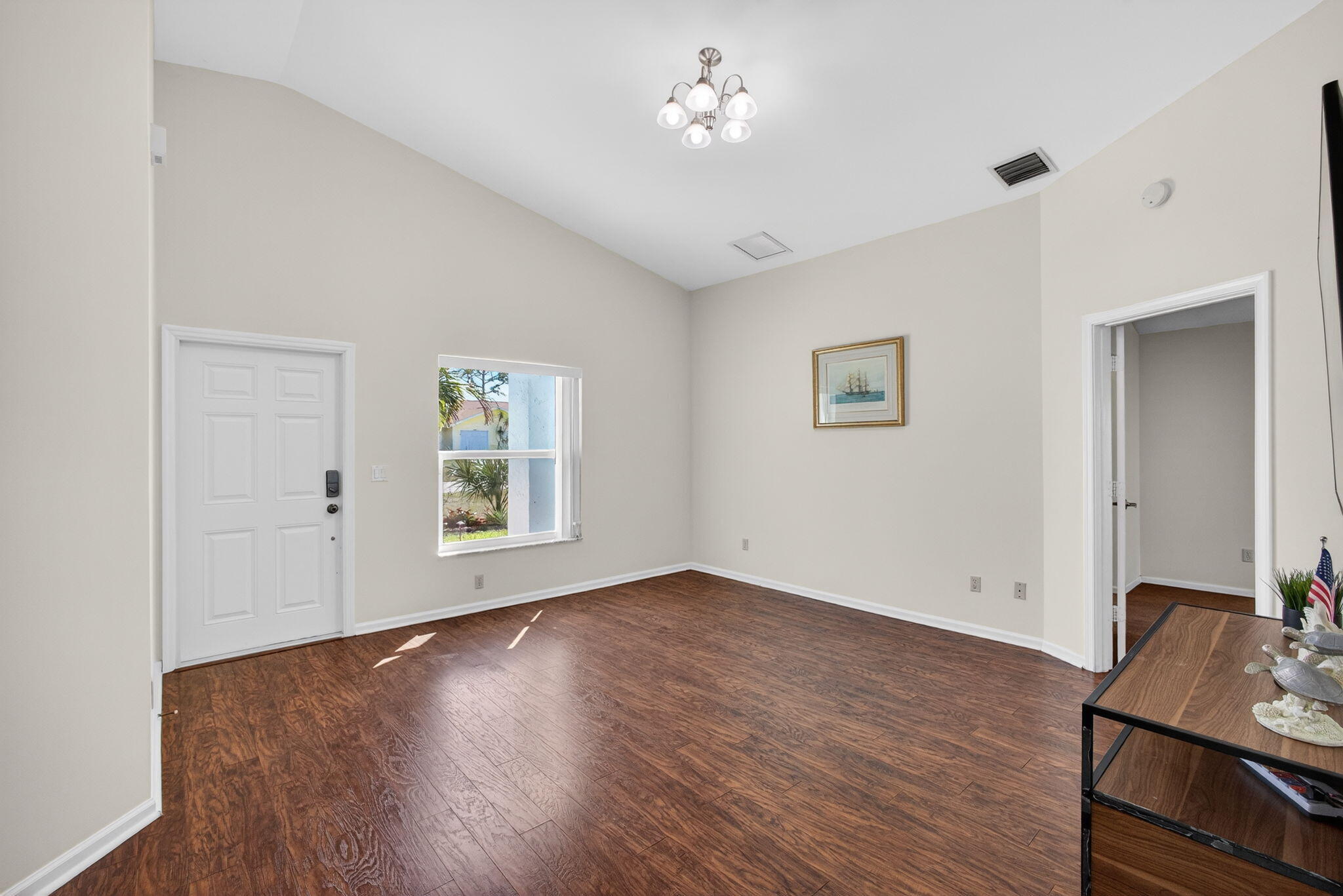 6223 Kendrick Street Jupiter, FL 33458 - Photo 4 of 45 a view of an empty room with wooden floor and a window