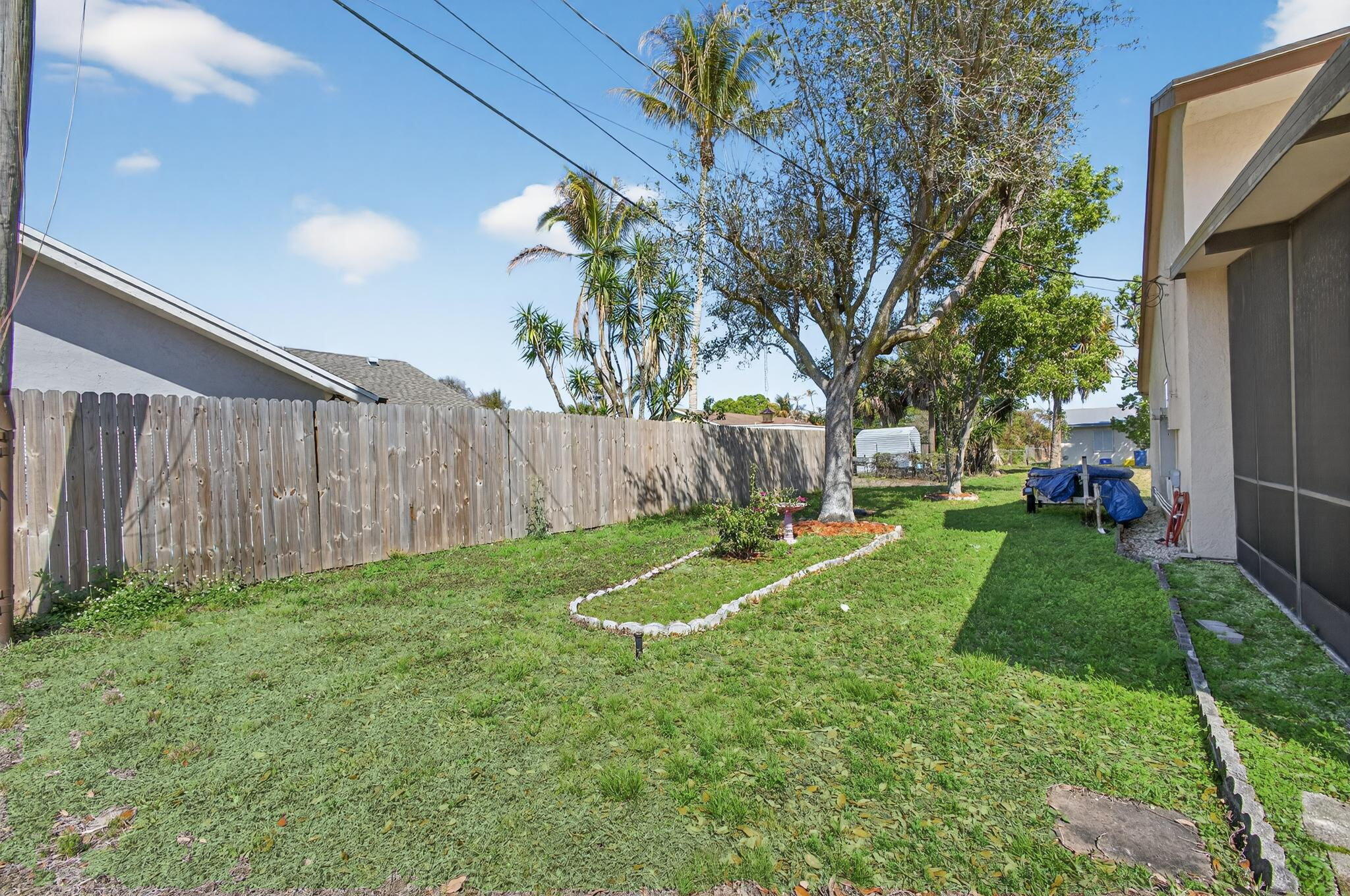 6223 Kendrick Street Jupiter, FL 33458 - Photo 41 of 45 a view of a backyard with a garden