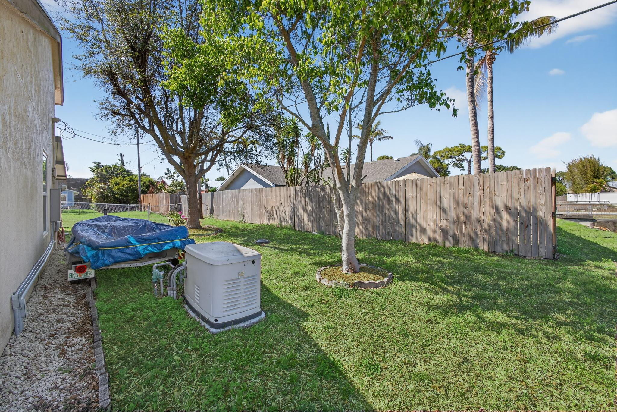 6223 Kendrick Street Jupiter, FL 33458 - Photo 43 of 45 a view of a backyard with garden and plants