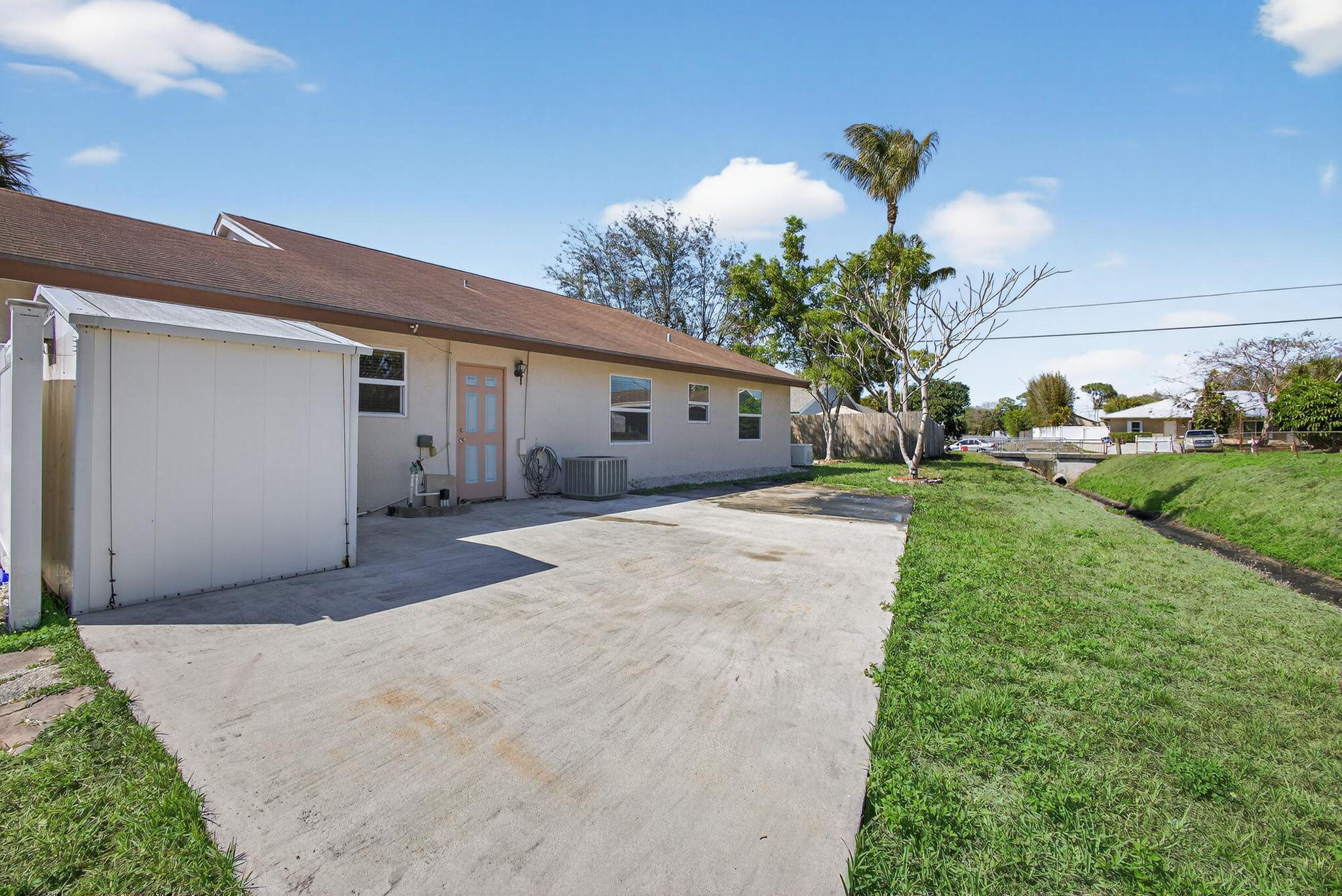 6223 Kendrick Street Jupiter, FL 33458 - Photo 44 of 45 a front view of a house with a yard and garage
