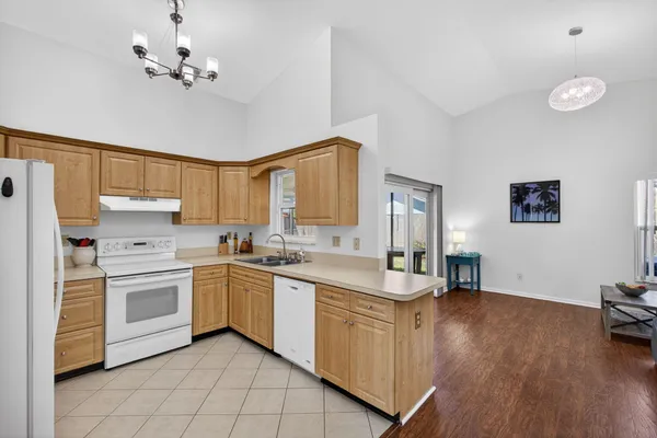 a kitchen with a stove sink and cabinets