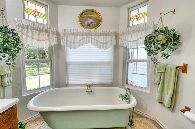 a bath tub sitting next to a window