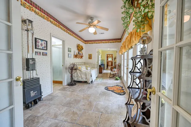 a view of a livingroom with furniture and a fan
