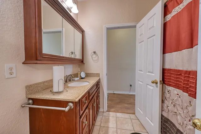 a bathroom with a sink a vanity and a mirror