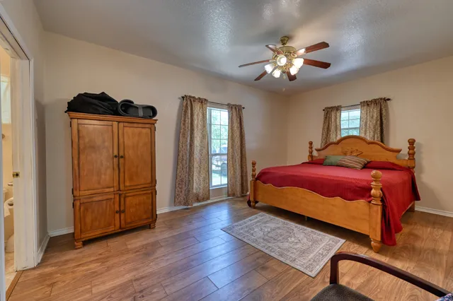 a bedroom with a large bed and a chandelier