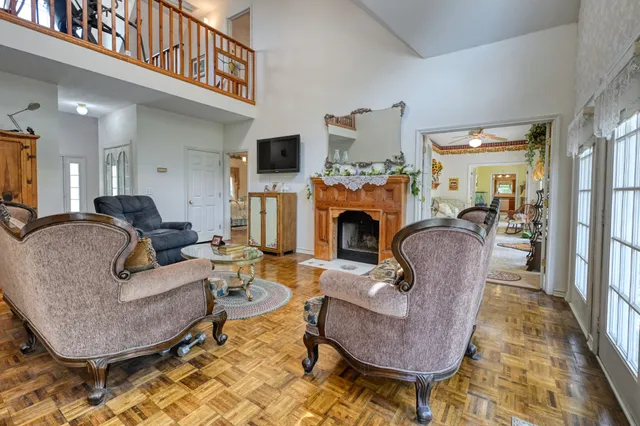 a living room with furniture a fireplace and a table