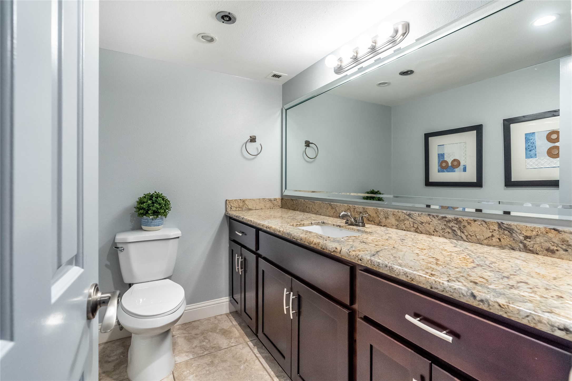 3525 Sage Road, Unit 1511 Houston, TX 77056 - Photo 9 of 25 a bathroom with a granite countertop toilet sink and mirror