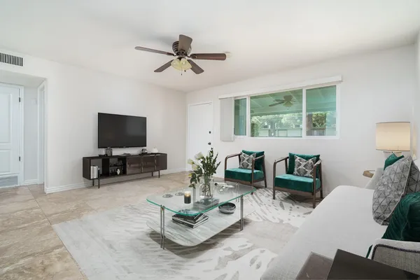 a living room with furniture and a flat screen tv