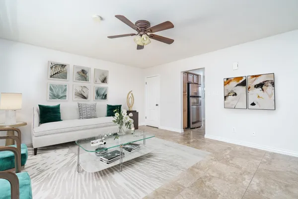a living room with furniture and wooden floor