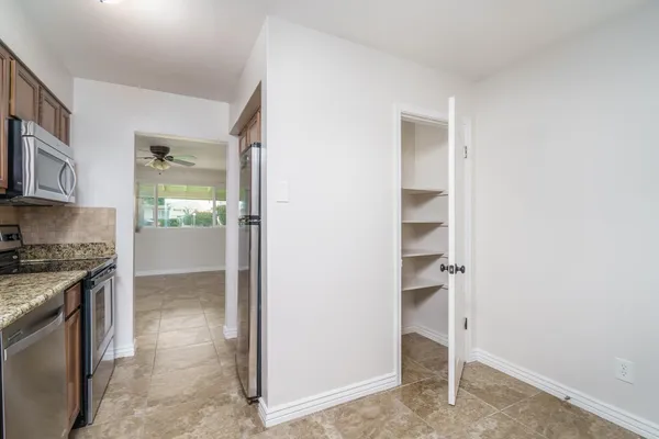 a view of a kitchen with a sink cabinets and a window