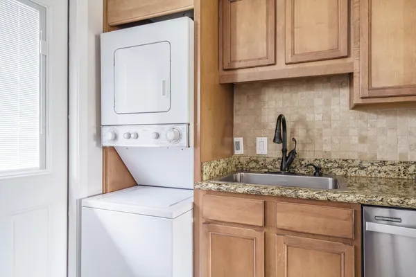 a kitchen with cabinets appliances and a sink
