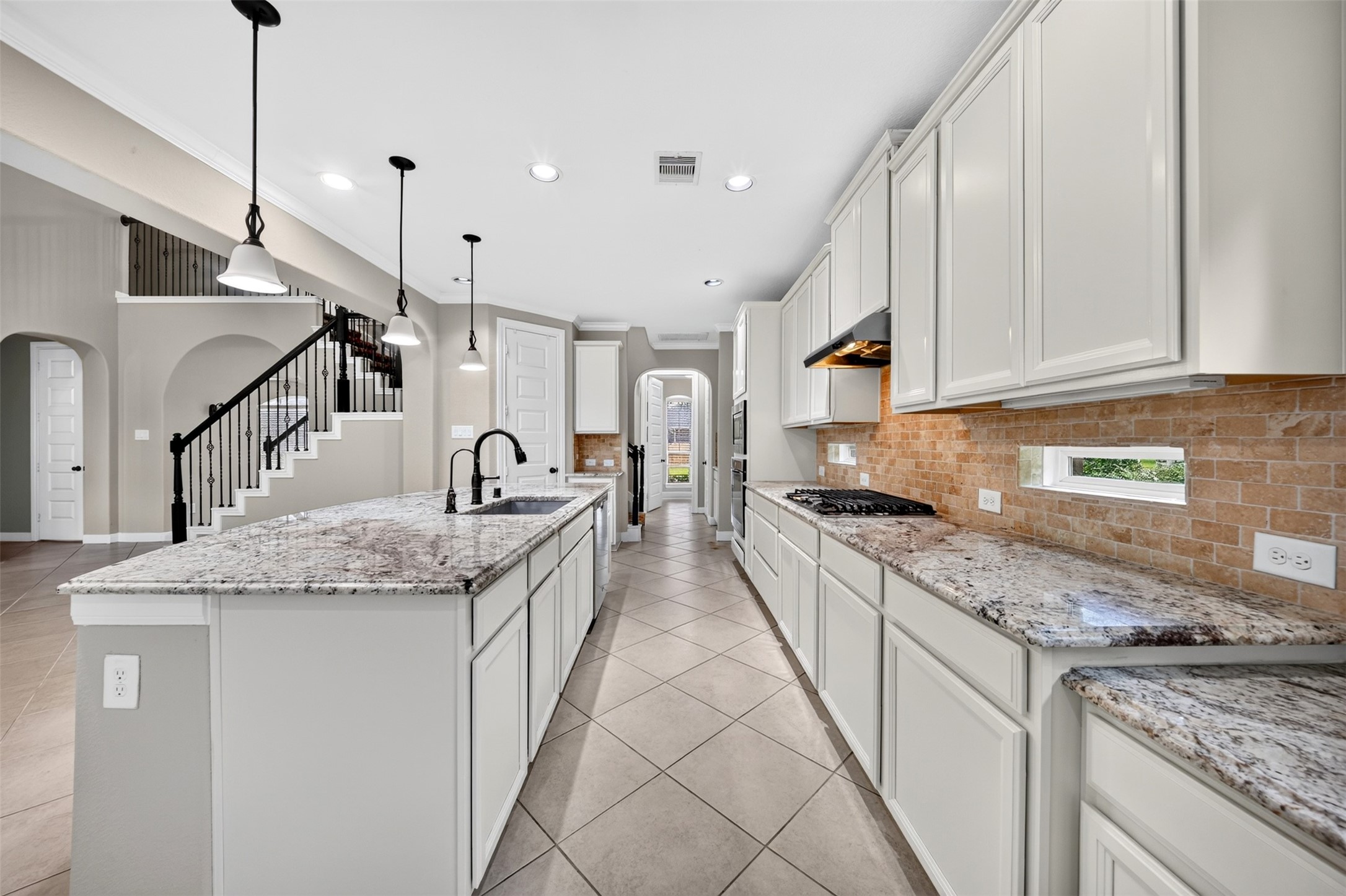 6234 Avon Landing Lane Spring, TX 77379 - Photo 17 of 49 This kitchen feels expansive thanks to the abundance of granite countertops, cabinetry, soaring ceilings and the seamless flow into the family room.