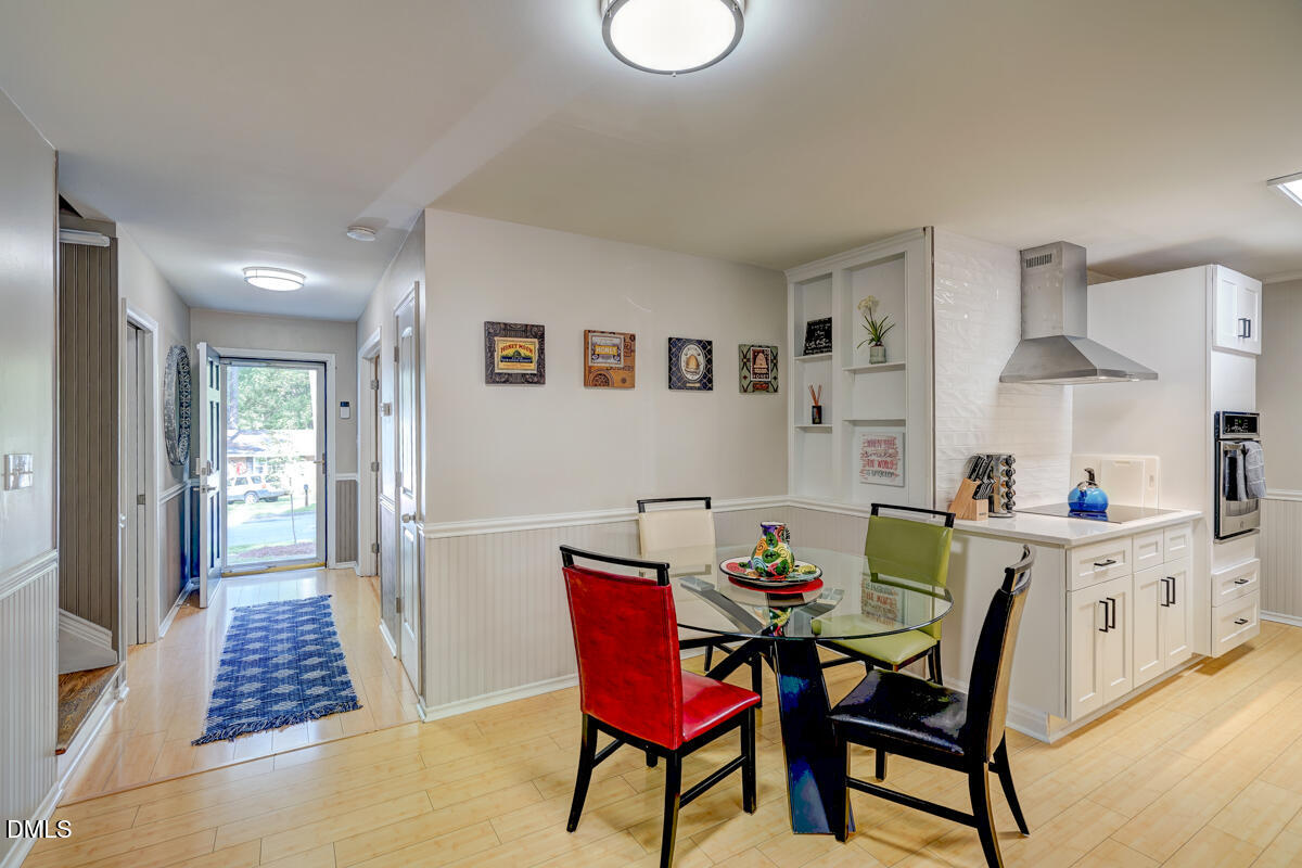 3418 Huntleigh Drive Raleigh, NC 27604 - Photo 14 of 55 a view of a dining room with furniture and wooden floor