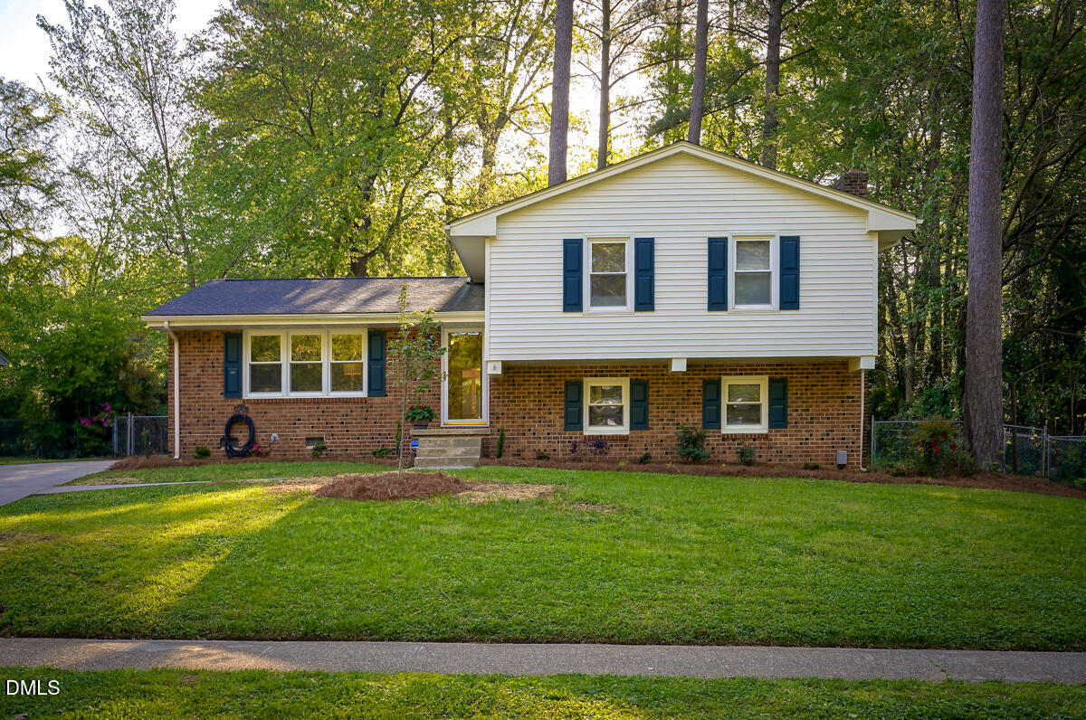 3418 Huntleigh Drive Raleigh, NC 27604 - Photo 2 of 55 a front view of a house with a yard and trees