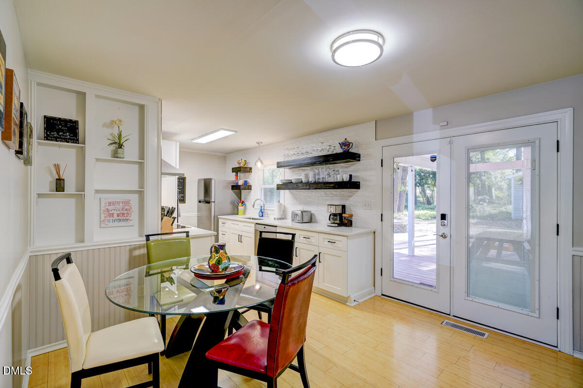 3418 Huntleigh Drive Raleigh, NC 27604 - Photo 22 of 55 a view of a dining room with furniture and a chandelier
