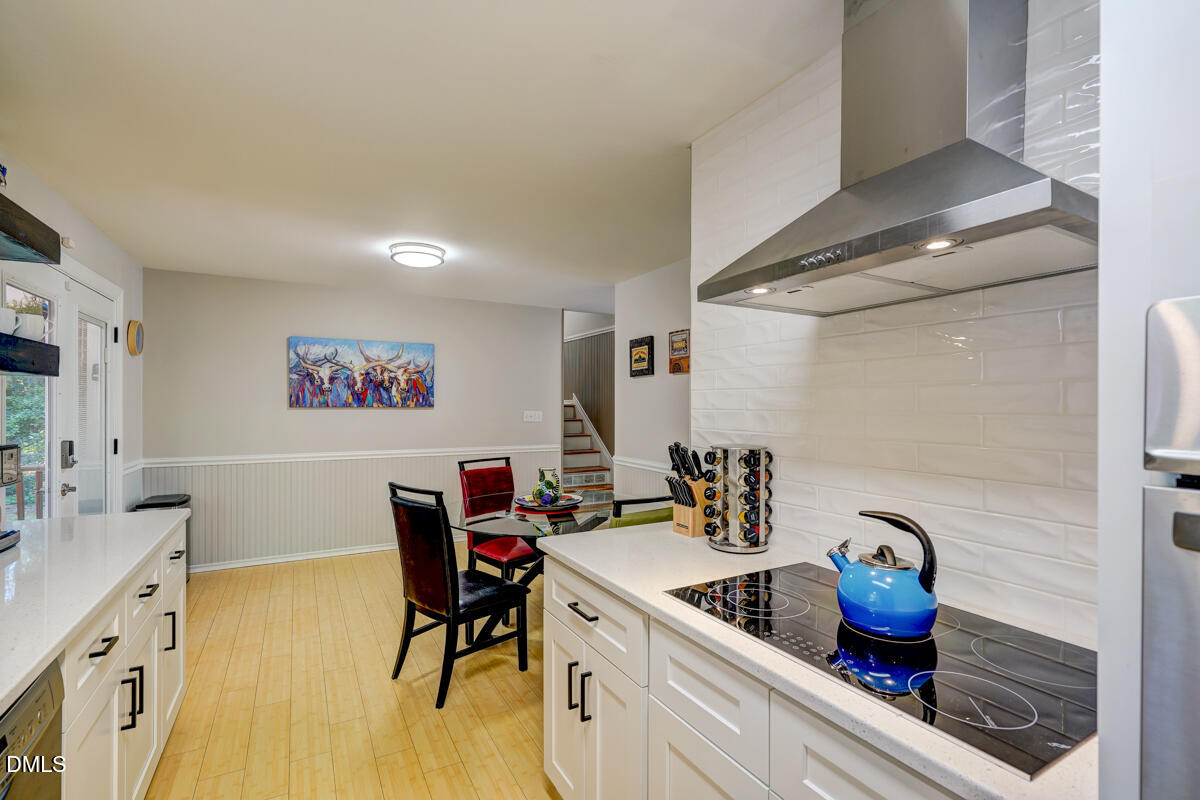 3418 Huntleigh Drive Raleigh, NC 27604 - Photo 29 of 55 a kitchen with a sink and a stove next to a window
