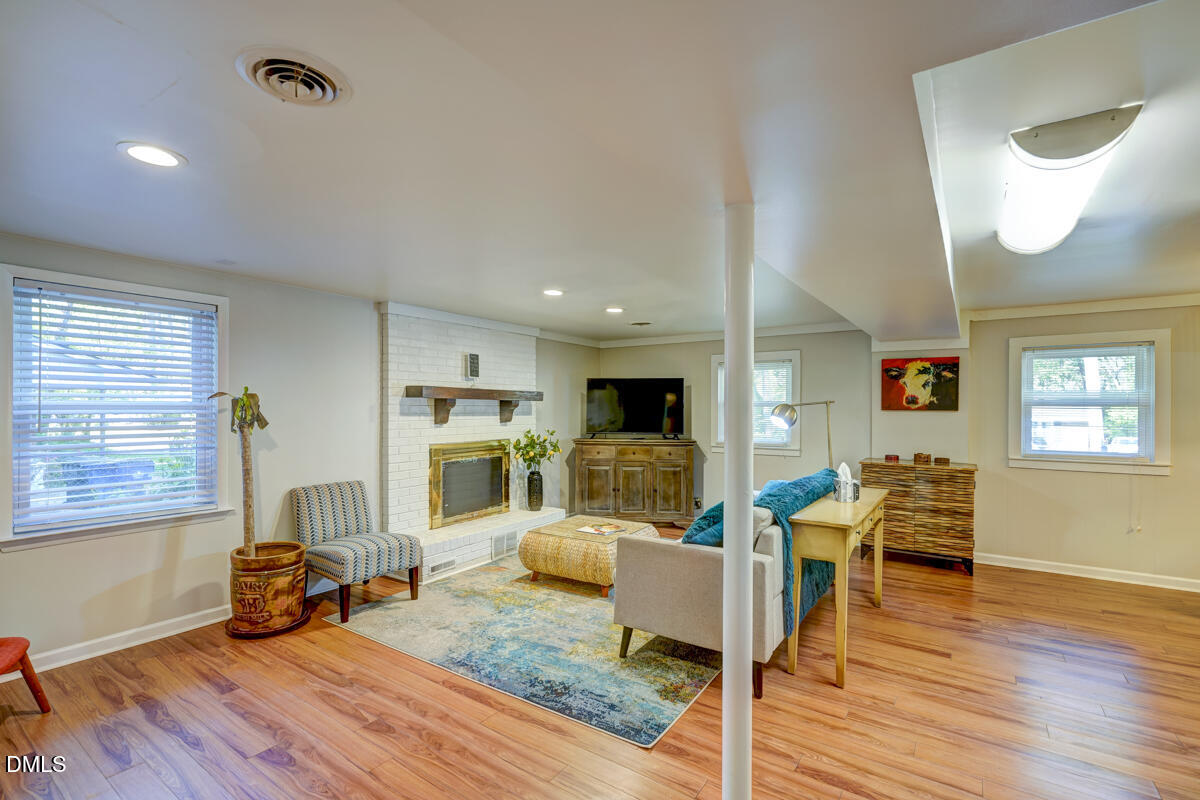 3418 Huntleigh Drive Raleigh, NC 27604 - Photo 30 of 55 a living room with furniture and a wooden floor