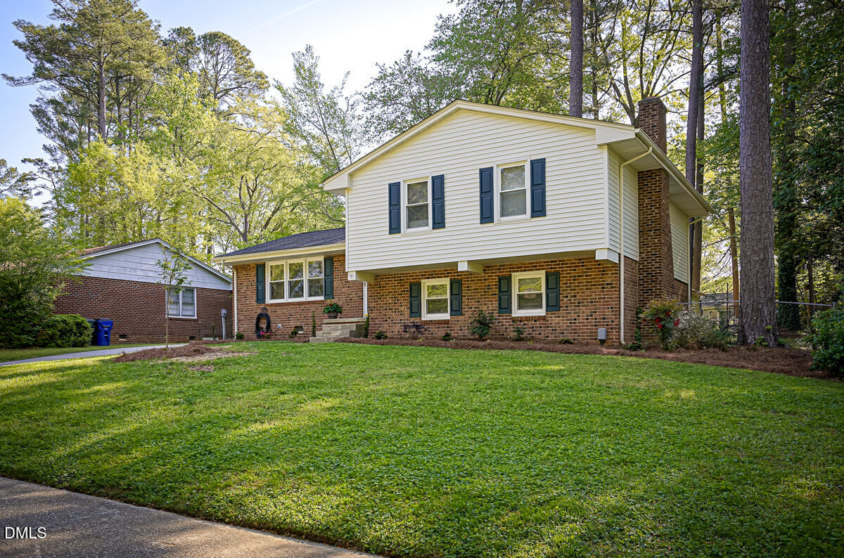 3418 Huntleigh Drive Raleigh, NC 27604 - Photo 3 of 55 a front view of a house with a garden