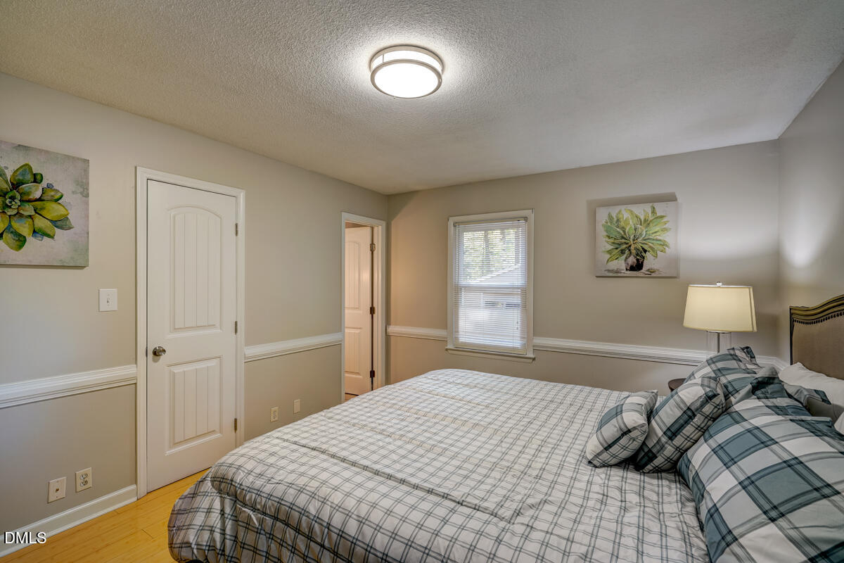 3418 Huntleigh Drive Raleigh, NC 27604 - Photo 37 of 55 a bedroom with a bed and a window