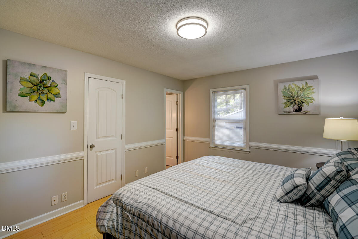 3418 Huntleigh Drive Raleigh, NC 27604 - Photo 38 of 55 a bedroom with a bed and a window