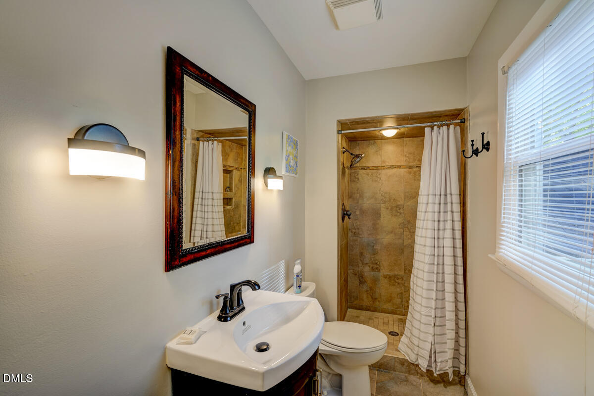 3418 Huntleigh Drive Raleigh, NC 27604 - Photo 39 of 55 a bathroom with a toilet sink and shower