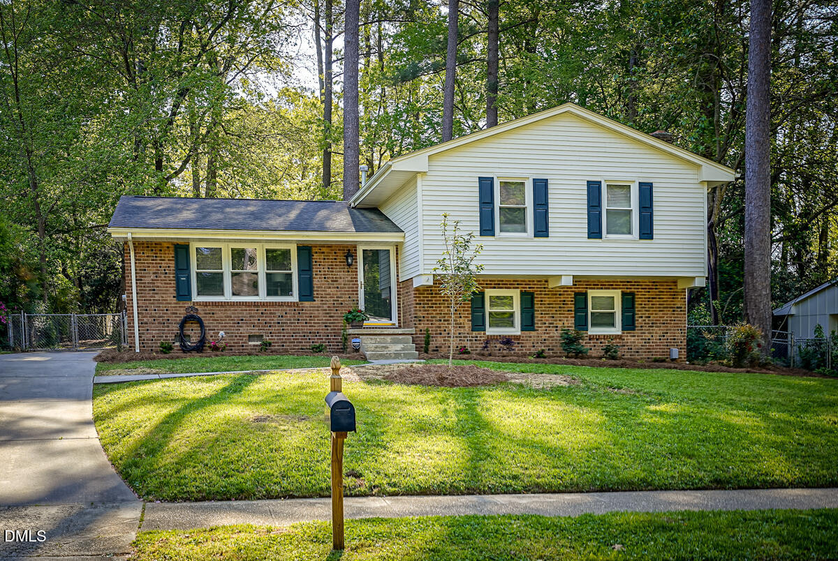 3418 Huntleigh Drive Raleigh, NC 27604 - Photo 4 of 55 a front view of a house with swimming pool and trees